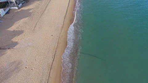 Aerial drone view of sandy beach and clear turquoise water Stock Footage 320453393