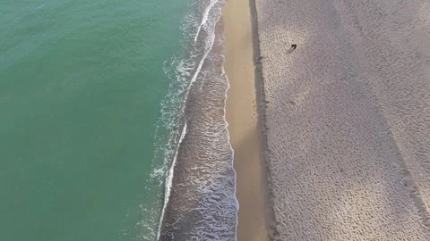 Aerial drone view of sandy beach and turquoise sea waves Stock Footage 320453844