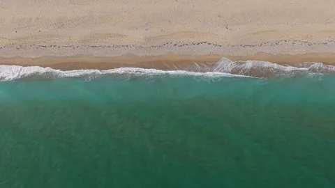 Aerial drone view of sandy beach shoreline and turquoise sea Stock Footage 321331307
