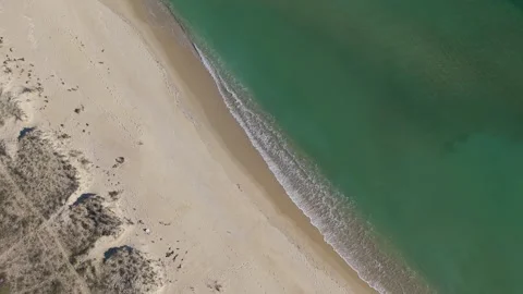 Aerial drone view of sandy beach and emerald sea shoreline Stock Footage 324529568