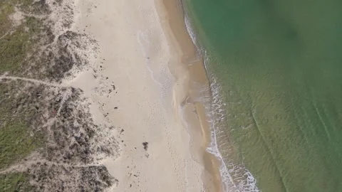 Aerial drone view of sandy beach and emerald sea shoreline Stock Footage 324529592