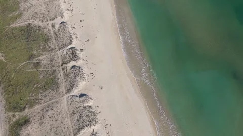 Aerial drone view of sandy beach and emerald sea shoreline Stock Footage 324529593
