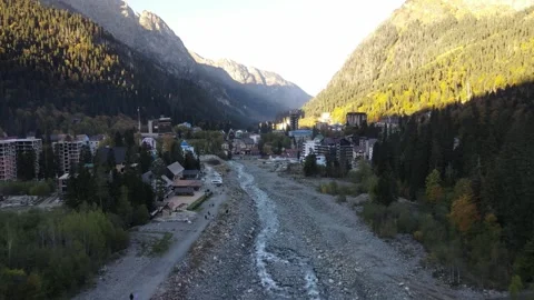 Aerial drone view of a scenic mountain town with a river Stock Footage 337529035