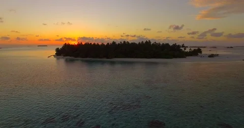 Aerial drone view of a scenic tropical island in the Maldives at sunset. Stock Footage