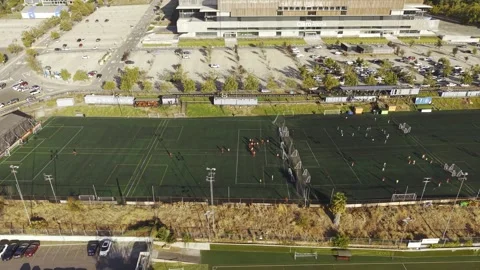 Aerial drone view of several active football matches on green turf fields San Stock Footage 332560431