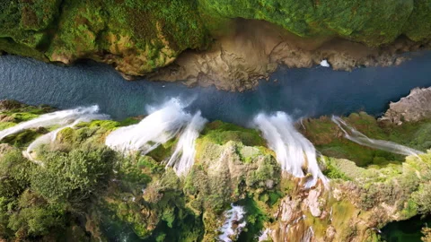 Aerial drone view of several powerful waterfalls dropping into a narrow canyon Stock Footage 321907345