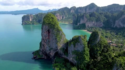 Aerial drone view of sheer limestone cliffs and turquoise bay in Krabi, Thailand Stock Footage 345545216