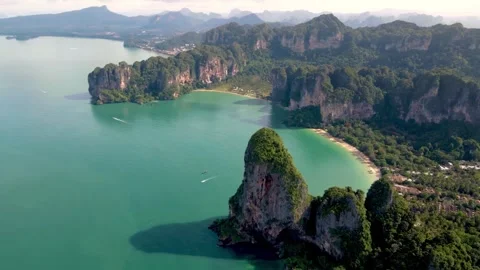 Aerial drone view of sheer limestone cliffs and turquoise bay in Krabi, Thailand Stock Footage 345545233