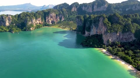 Aerial drone view of sheer limestone cliffs and turquoise bay in Krabi, Thailand Stock Footage 345545238