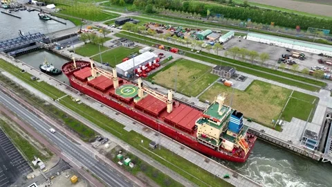 Aerial drone view of a ship passing through a canal sea lock in the Netherlands Stock Footage 301204392
