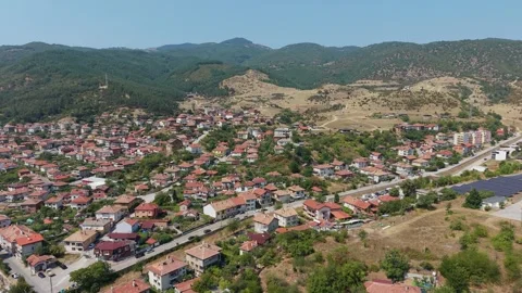 Aerial drone view of Simitli town with red roof houses in Bulgaria Stock Footage 343578438