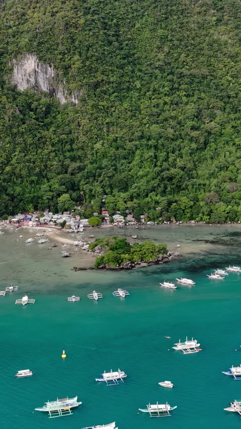 Aerial drone view of a small coastal village connected by a narrow sandbar and Stock Footage 332472097