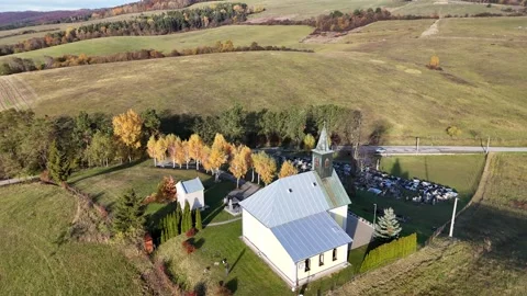 Aerial drone view of a small countryside church with autumn trees Stock Footage 328627599