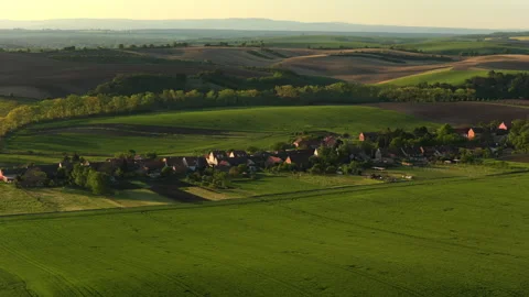 Aerial drone view of a small Czech village with red-tiled rooftops set amid Stock Footage 336625914
