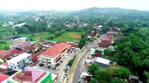 Aerial Drone View of Small Town Main Street, Buildings, and Hills in Indonesia Stock Footage 347429142