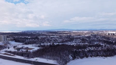 Aerial drone view of snow covered city and frozen river Stock Footage 328962992