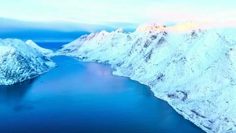 Aerial drone view of snow covered mountain peaks above deep blue fjord. Stock-Footage 341133256