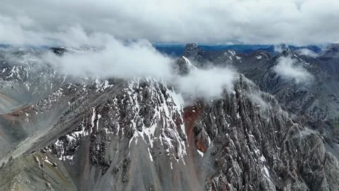 Aerial Drone View of Snowy Mountain Peaks and Clouds in Western Sichuan Stock Footage 336710558