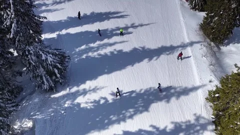 Aerial drone view of snowy ski slopes with many skiers skating. Stockbeeldmateriaal 332113699