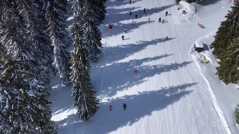 Aerial drone view of snowy ski slopes with many skiers skating. Stockbeeldmateriaal 332736330