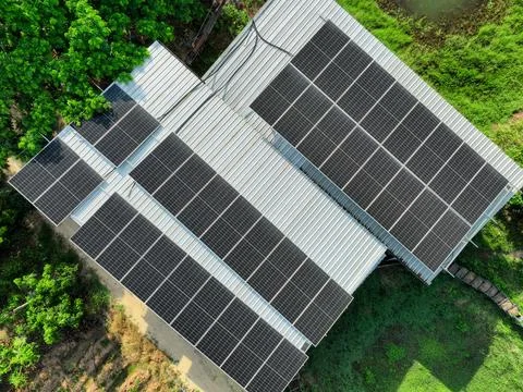 Aerial drone view of solar panel installation on metal rooftop of rural hou.. Stock Photos