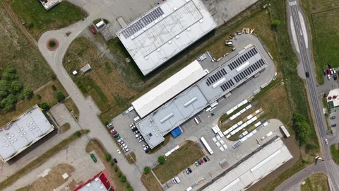 An aerial drone view of a sprawling industrial logistics hub featuring multiple Vídeos de archivo 336014680
