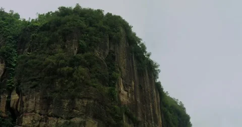 Aerial drone view of steep mountain cliff covered by moving fog Video stock 333407628