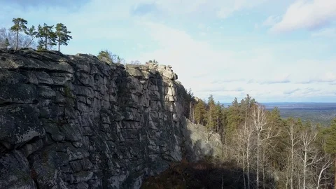 Aerial; drone view of steep stone cliff; high mountaine range, Ural Stock Footage 108650932