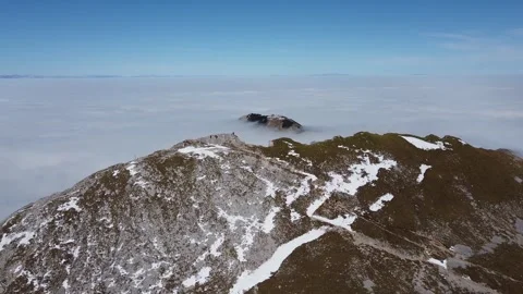 Aerial Drone View of Stol Mountain Peak Above Low Clouds in Slovenia Stock Footage 329319498