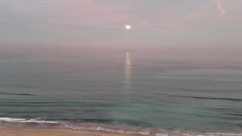 Aerial drone view of a stunning moon above the sea during early morning Stock Footage 298005134