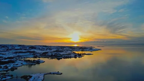 Aerial drone view of sunrise over snowy coastal landscape 库存影片 345100895