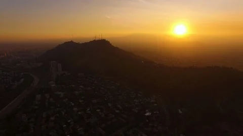 Aerial Drone view, sunset over Cerro San Cristobal hill, Santiago de Chile Stock Footage 100862479