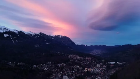 Aerial drone view of sunset sky over a city near mountains Stock Footage 297219846