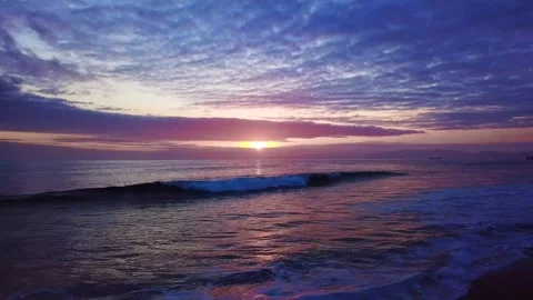 Aerial Drone view of a Sunset as the waves crash on the Beach Stock Footage 329258920