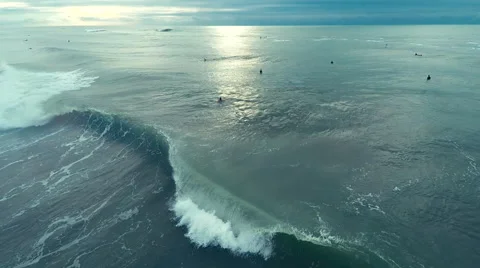 Aerial drone view of surfers catching waves in the ocean Stock Footage