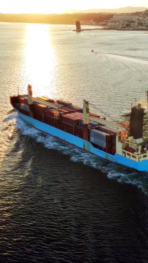Aerial drone view of Tagus River with container ship at sunset. Lisbon, Portugal Video stock 344584364