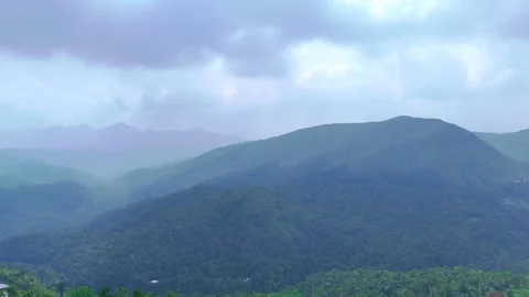 Aerial Drone View of Tea Plantations with Mountains in the Background Stock Footage 323799786