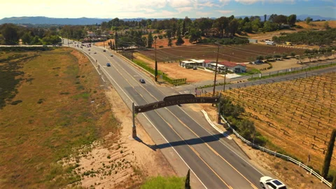 Aerial Drone View of Temecula Valley Wine Country Sign Over Vineyard Road Stock Footage 331324707