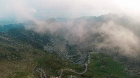 Aerial drone view through the clouds fog of Transfagarasan mountain road trip Video stock 97065735