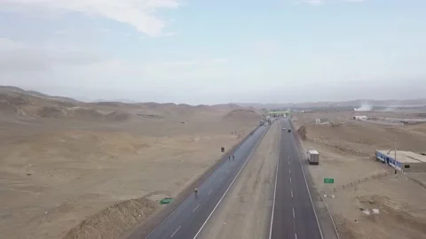 Aerial drone view of a toll road between cars and trucks in the desert at cloudy Видео 197584553