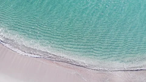 Aerial drone view top view waves crashing empty beach from above. Stock Footage 134594094