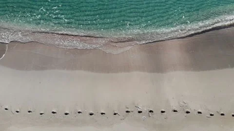 Aerial drone view top view foamy long waves crashing Stock Footage 135063599