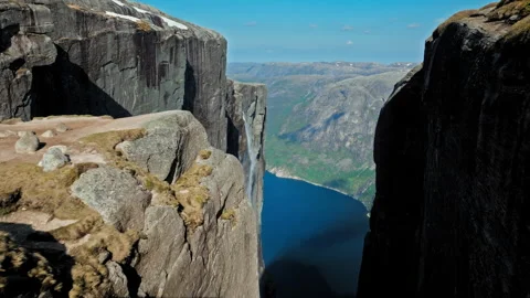 Aerial drone view of towering granite cliffs at Kjerag above Lysefjord Norway. Stock Footage 328129384