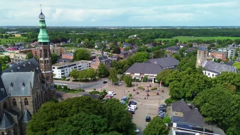 Aerial drone view of a town square with a parking lot, cars, trees Видео 315409933