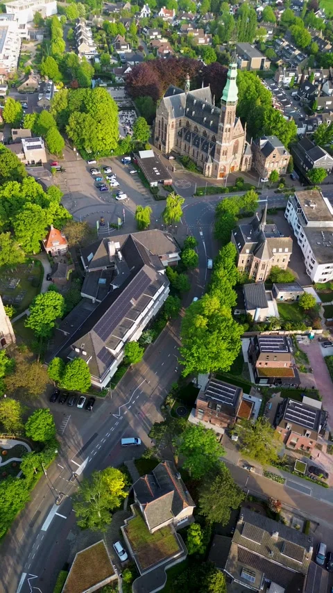 Aerial drone view of a town square with a parking lot, cars, trees Stock-Footage 317447240