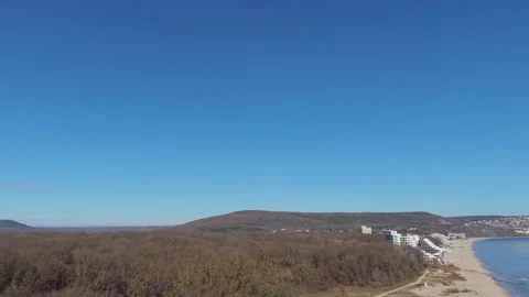 Aerial drone view of town surrounded by hills and forest Stock Footage 324529647