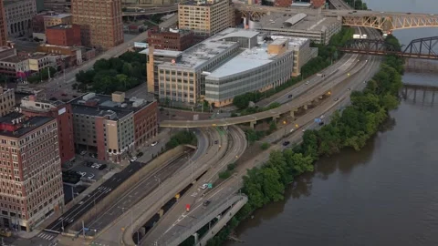Aerial drone view tracking over an urban highway system and riverside roads Stock Footage 337711463