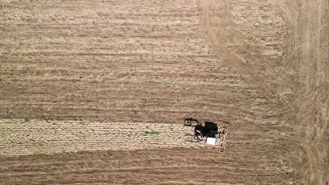 Aerial Drone View of Tractor Plowing Agricultural Field Stock Footage 332565311