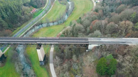 Aerial drone view on train bridge with passing train Stock Footage 224374433