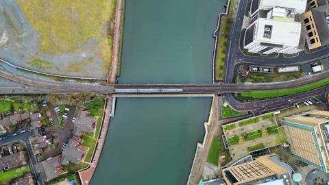 Aerial drone view of a train moving over the Belfast Railway Bridge above River Stock Footage 315428441